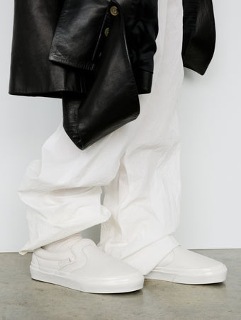 Image of model wearing Vans x Proenza Schouler Puffy Slip-On Shoes in ecru