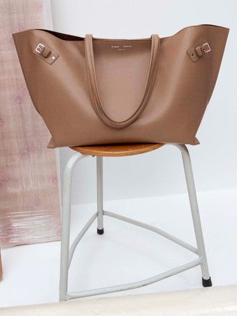 Image of Days Carryall in Smooth Calf in Cumin on a chair