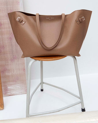 Image of Days Carryall in Smooth Calf in Cumin on a chair
