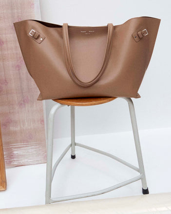 Image of Days Carryall in Smooth Calf in Cumin on a chair