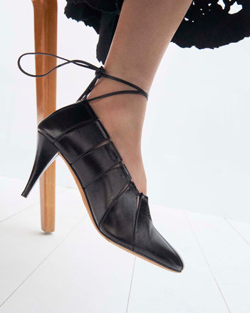 Cropped image of model wearing the Glove Hinge Pumps in Black