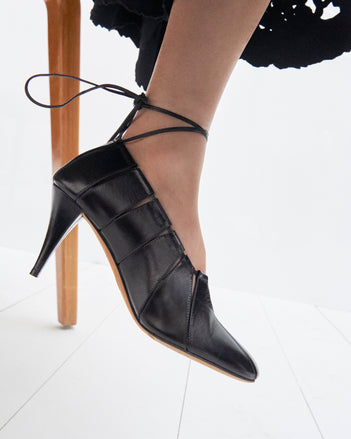 Cropped image of model wearing the Glove Hinge Pumps in Black