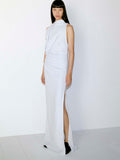 Model standing against white wall in Devyn Dress in Matte Double Crepe in Powder Blue