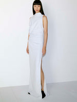 Model standing against white wall in Devyn Dress in Matte Double Crepe in Powder Blue