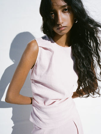 Proenza Schouler Editorial cropped image of model standing in front of white background wearing the Anoushka Top in Linen Slub in Orchid