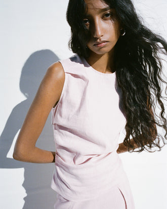 Proenza Schouler Editorial cropped image of model standing in front of white background wearing the Anoushka Top in Linen Slub in Orchid