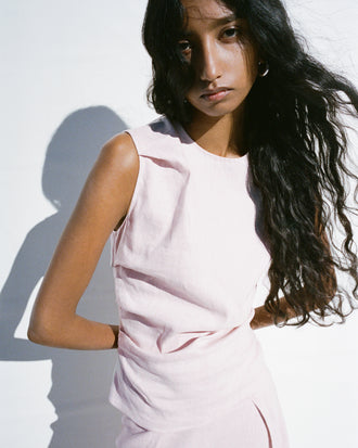 Proenza Schouler Editorial cropped image of model standing in front of white background wearing the Anoushka Top in Linen Slub in Orchid