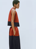 Proenza Schouler editorial image of model wearing the Esme Top in Poplin in Brick/Black with matching Nyla Skirt in Poplin in Brick/Black