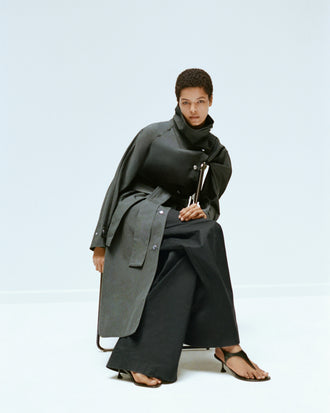 Proenza Schouler Editorial Image of model wearing Corey Trench in Washed Cotton in Willow with the Coralie Pant in Poplin in Black with the Tee Thong Sandal in Black