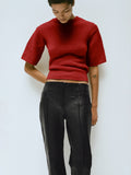 Proenza Schouler Editorial Image of Model wearing the Dana Sweater in Wool in Brick with the Isadora Pant in Leather in Black