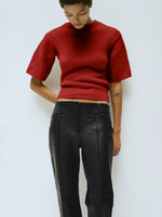 Proenza Schouler Editorial Image of Model wearing the Dana Sweater in Wool in Brick with the Isadora Pant in Leather in Black