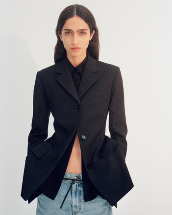 Cropped image of model wearing Lark Blazer in black and Ellsworth Jeans in classic wash