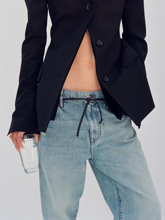 Cropped image of model wearing Lark Blazer in black and Ellsworth Jeans in classic wash