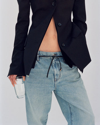 Cropped image of model wearing Lark Blazer in black and Ellsworth Jeans in classic wash