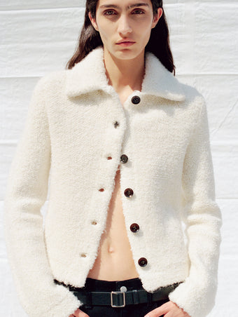 Cropped image of model wearing Sylvie Jacket in Loop Boucle Knit in ivory