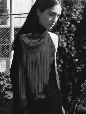 Cropped black and white image of model wearing Everly Dress in Viscose Fringe Knit in black