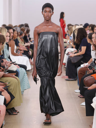 Runway image of model in Margot Dress In Glossy Leather in black