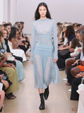 Runway image of model wearing Riley Dress In Pleated Jersey in steel