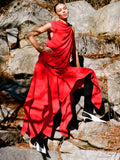 Image of model wearing Denise Dress in Light Matte Double Crepe in Red standing on rocky terrain
