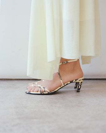 Detailed image of the Uma Sandal in Python and bottom of the Tamara Dress