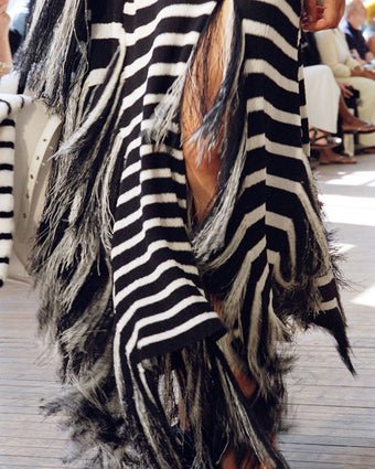 Cropped image of model walking Proenza Schouler Spring Summer 2025 Runway wearing Yves Top and Skirt in Stripe Fringed Knit in navy multi