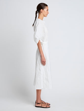 Proenza Schouler Side full length image of model wearing Alicia Dress in Crinkled Cotton Gabardine in WHITE
