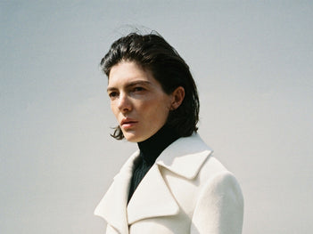 A wide portrait of a model in the Proenza Schouler FW26 Campaign wearing the Romane Jacket