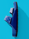 Aerial side image of Birkenstock x Proenza Schouler Arizona Slides in cobalt on tonal blue backdrop