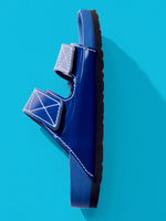Aerial side image of Birkenstock x Proenza Schouler Arizona Slides in cobalt on tonal blue backdrop