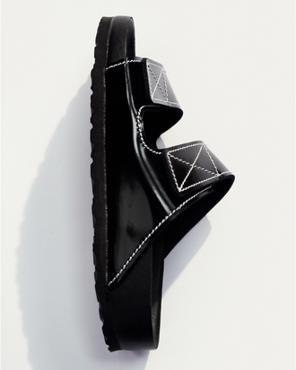 Aerial side image of Birkenstock x Proenza Schouler Arizona Slides in black on white backdrop