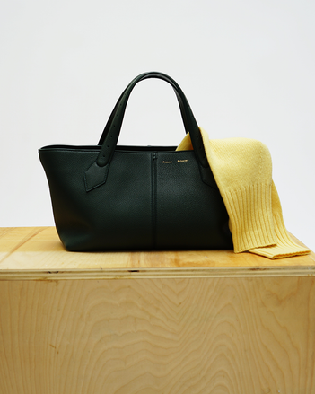 Still life image of the East West Chelsea Tote on a wood plinth against a white wall