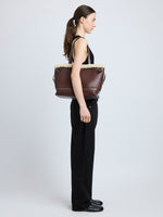 Proenza Schouler side image of model wearing Days Tote in Nappa Shearling in CHESTNUT