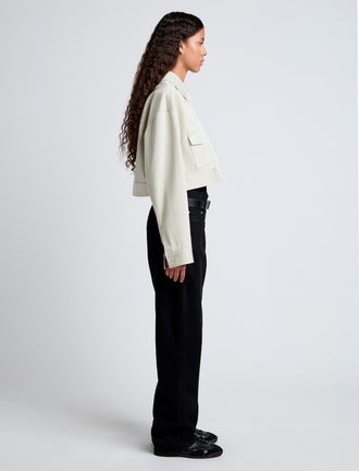 Side image of model wearing Dylan Jacket in Organic Cotton Twill in wheat