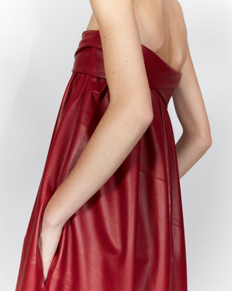 Cropped image of model in Nappa Leather Strapless Dress in crimson