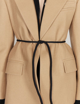 Cropped image of model in tan Wool Twill Jacket and black Strobel Belt