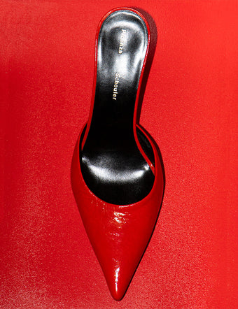 Spike Mules in red on tonal red backdrop