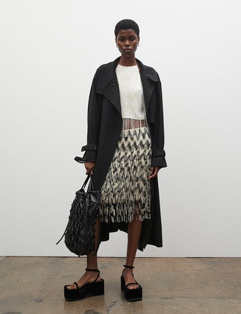 Model in Graphic Beaded Fringe Embroidered Top and Skirt, carrying Macrame Drawstring Tote in black
