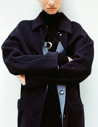 Cropped image of model in Reversible Double Face Coat in black/steel grey over Pointelle Diamonds Turtleneck Top in black