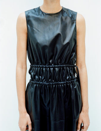 Cropped image of model in Faux Leather Drawstring Dress in black