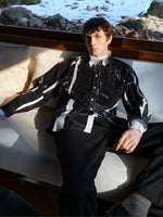 Proenza Schouler Front image of model sitting on a beige bench wearing Simon Shirt in Garment Print Poplin in White/ Black
