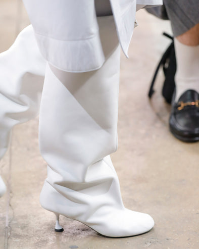 Image of model walking Proenza Schouler Fall Winter 2024 Runway Show wearing Tee Knee High Boots in white