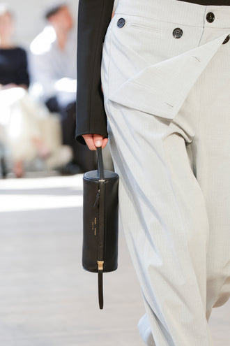 Detail image of model carrying Silo Bag in black in Proenza Schouler SS25 Runway Show