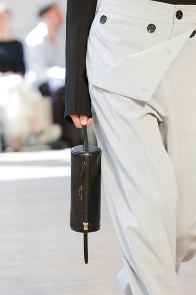 Detail image of model carrying Silo Bag in black in Proenza Schouler SS25 Runway Show