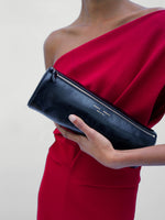 Proenza Schouler Detail image of model wearing Rosina Dress in Light Double Crepe in Scarlet holding a Silo