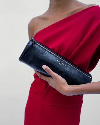 Proenza Schouler Detail image of model wearing Rosina Dress in Light Double Crepe in Scarlet holding a Silo