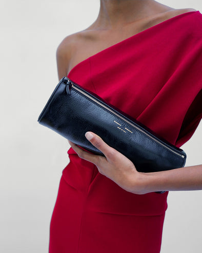 Proenza Schouler Detail image of model wearing Rosina Dress in Light Double Crepe in Scarlet holding a Silo