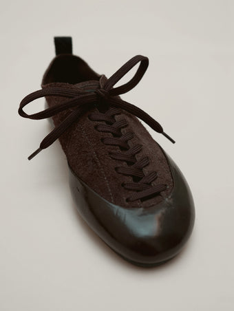 Proenza Schouler front 3/4 image of Arcadia Sneakers in Chocolate with light brown laces