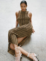 Proenza Schouler Editorial Image of model Laying on the concrete floor wearing the Maelle Top in Drop Needle Tweed Black Multi and the Maelle Skirt in Drop Needle Tweed in Black Multi with the Tee Knot Sandals in Nappa in White