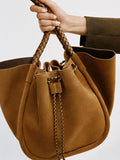 Proenza Schouler editorial cropped image of model holding the Large Ruched Tote in Suede and Braided Calf in Hazelnut 