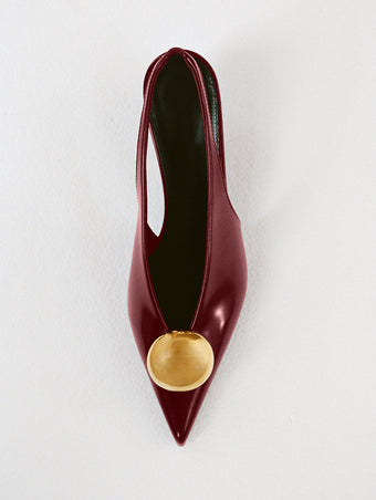 Proenza Schouler Editorial Still Life Image of Dome Slash Slingbacks in Polished Calf in Merlot 